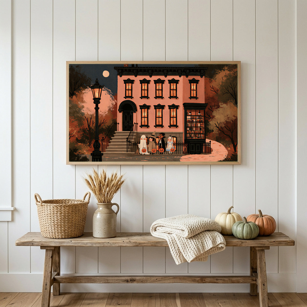 Trick or treat brownstone Frame TV art above a rustic bench with heirloom pumpkins on a white plank wall