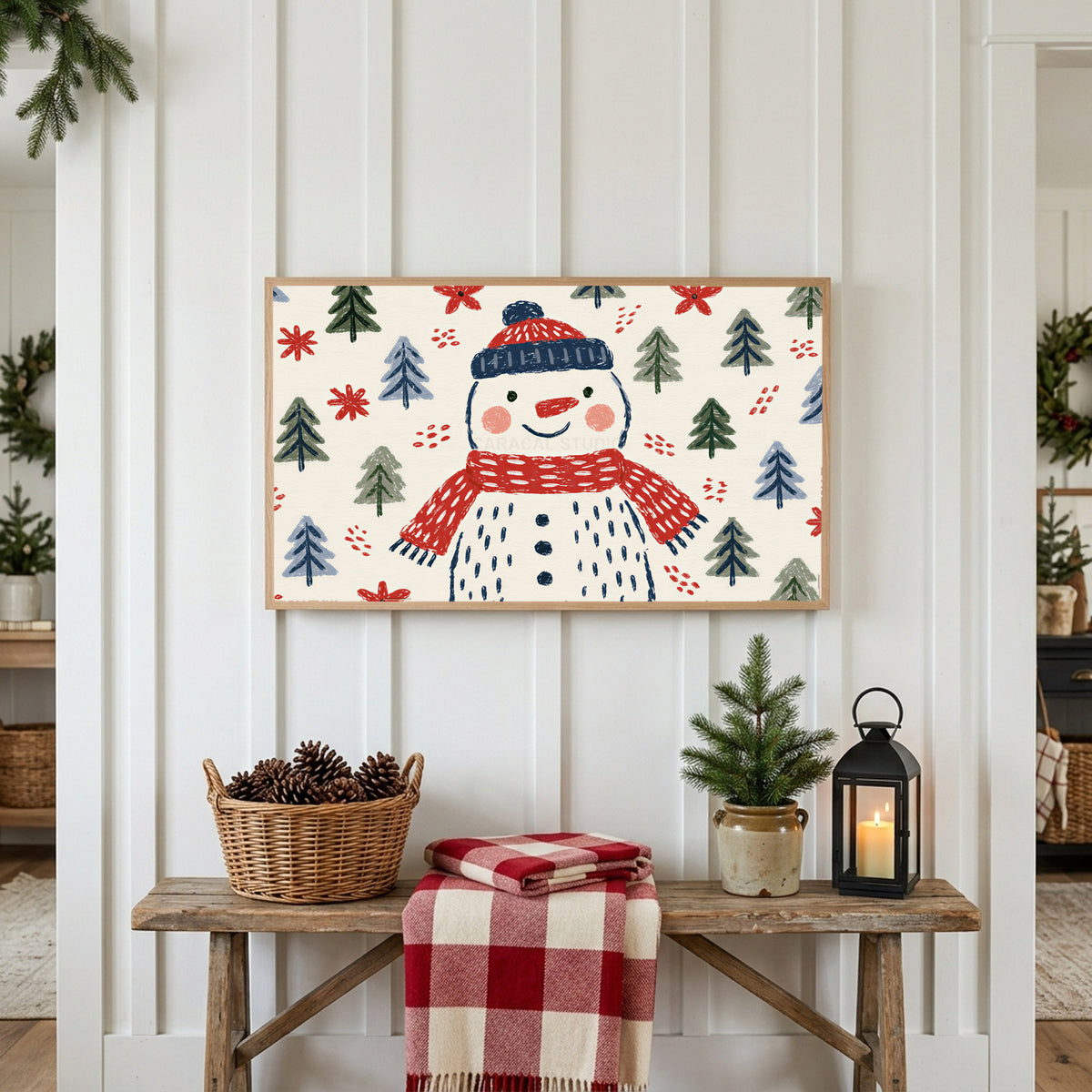 Snowman Frame TV art above a rustic bench with pine cones and a red check blanket on a white plank wall