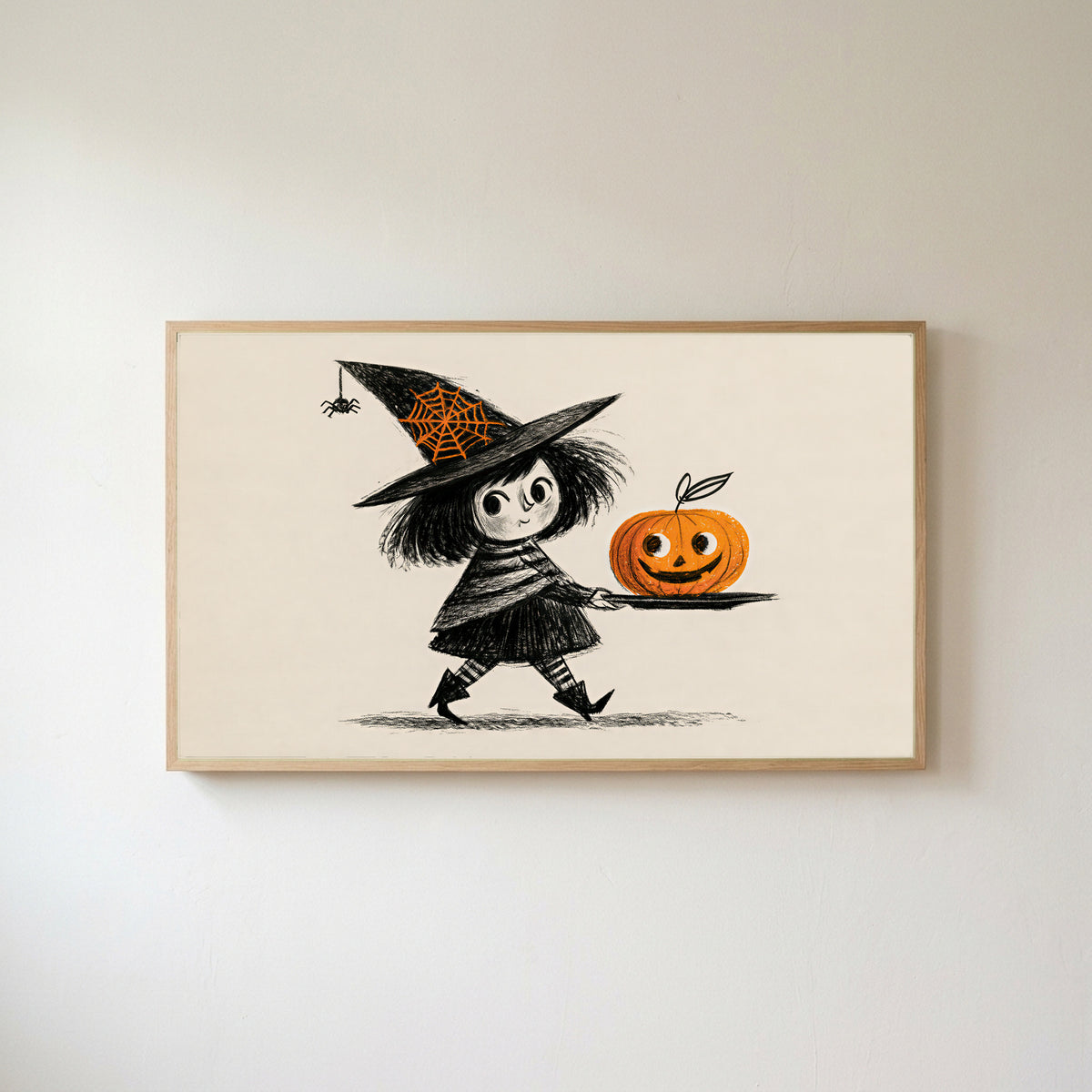 Frame TV art of a little witch with a jack-o'-lantern in an oak frame on a warm white wall