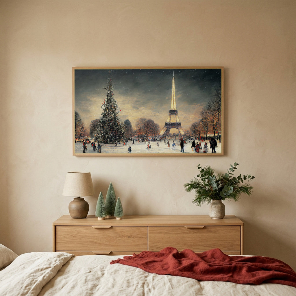 Paris in snow Christmas TV art above an oak dresser with small bottle-brush trees in a calm bedroom