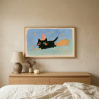 Black cat witch TV art above an oak dresser in a calm bedroom