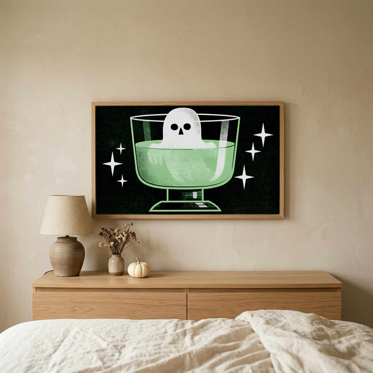 Ghost in a potion glass Halloween TV art above an oak dresser in a calm bedroom