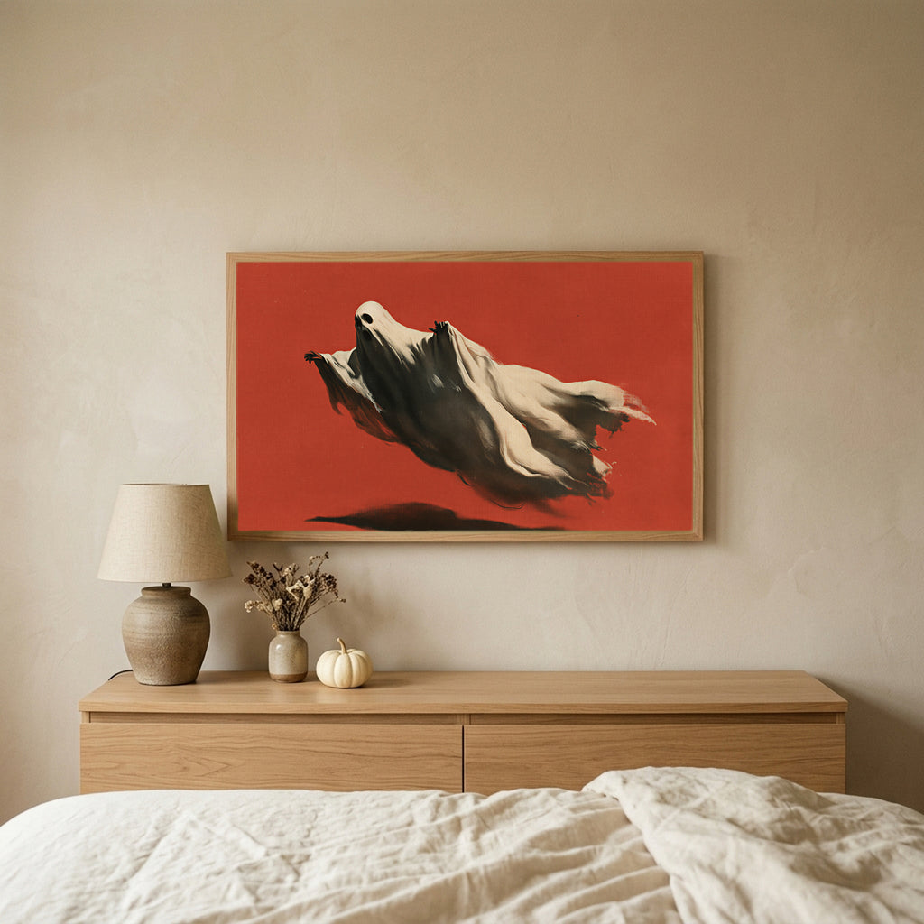 Flying ghost Halloween TV art above an oak dresser in a calm bedroom