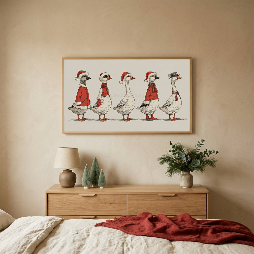 Geese in Santa hats TV art above an oak dresser with small bottle-brush trees in a calm bedroom