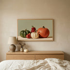 Pumpkin still life TV art above an oak dresser in a calm bedroom