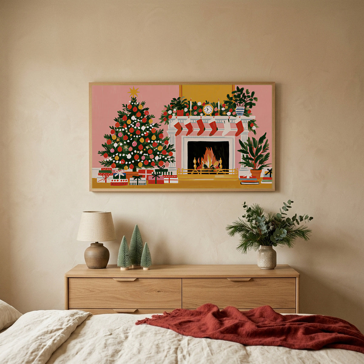 Tree and fireplace TV art above an oak dresser with small bottle-brush trees in a calm bedroom