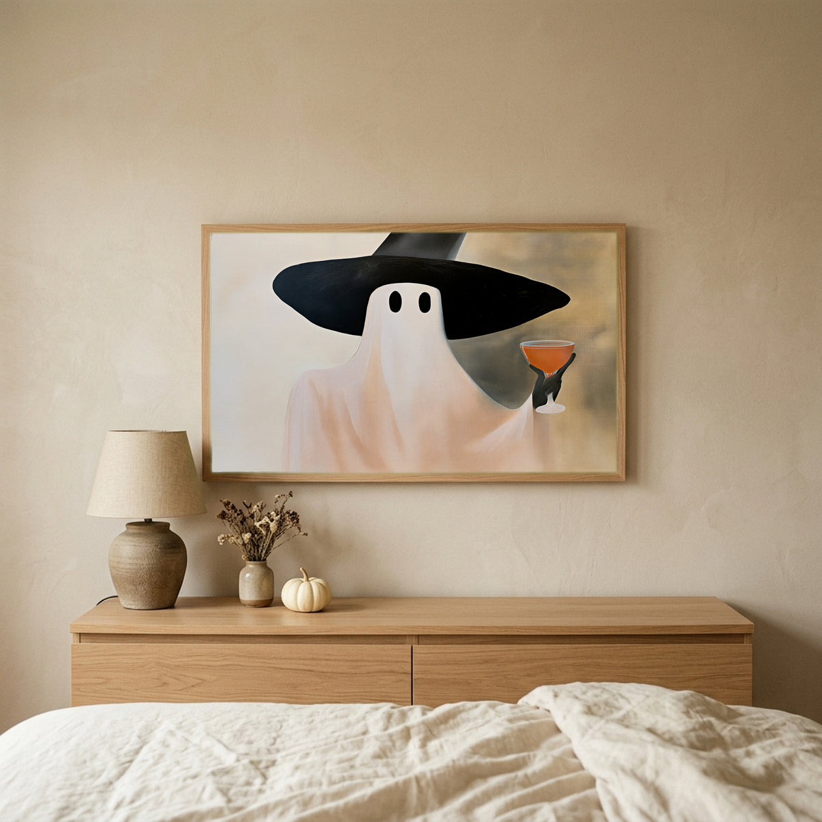 Ghost witch with a cocktail Halloween TV art above an oak dresser in a calm bedroom