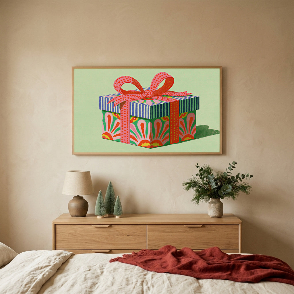 Gift box TV art above an oak dresser with small bottle-brush trees in a calm bedroom
