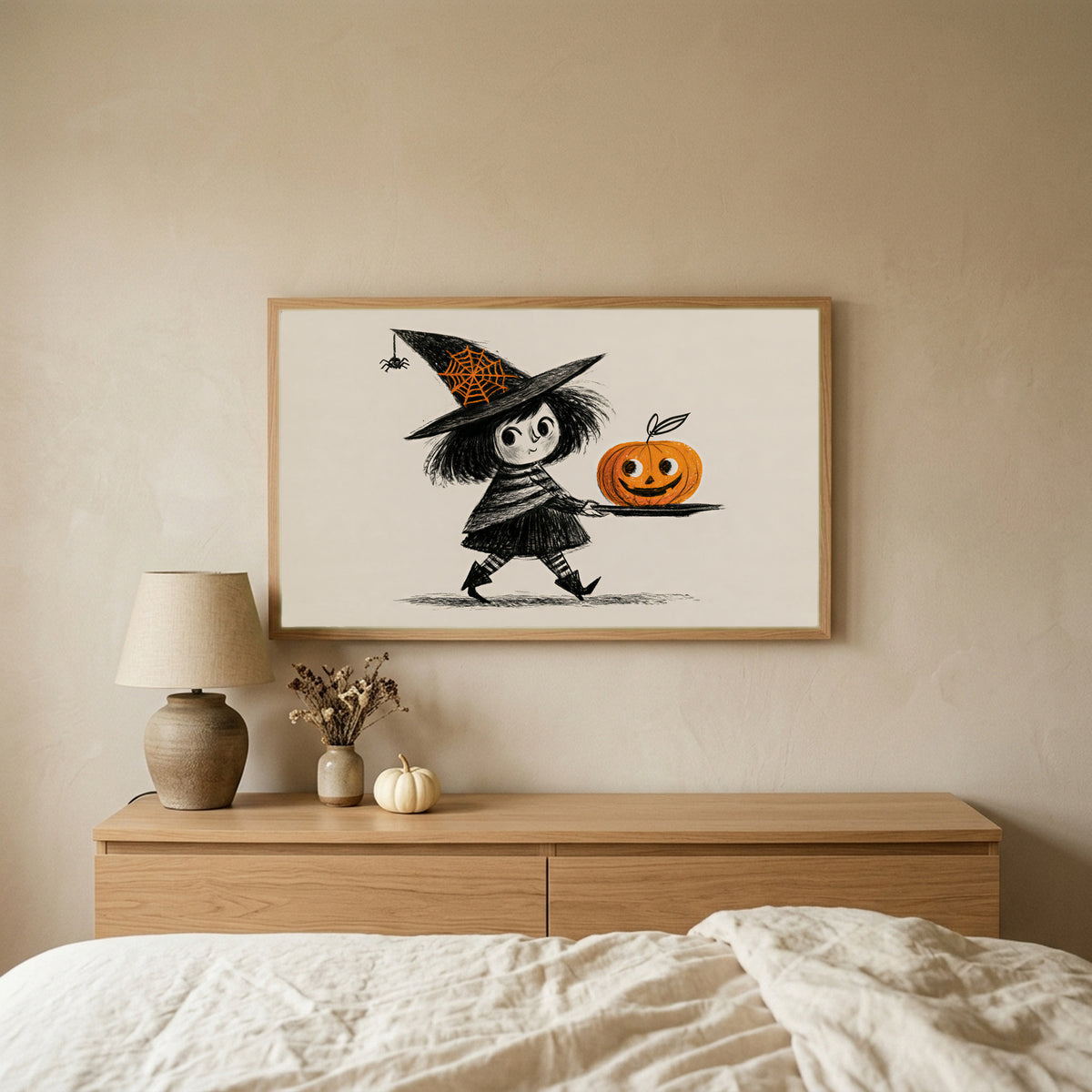 Little witch Halloween TV art above an oak dresser in a calm bedroom