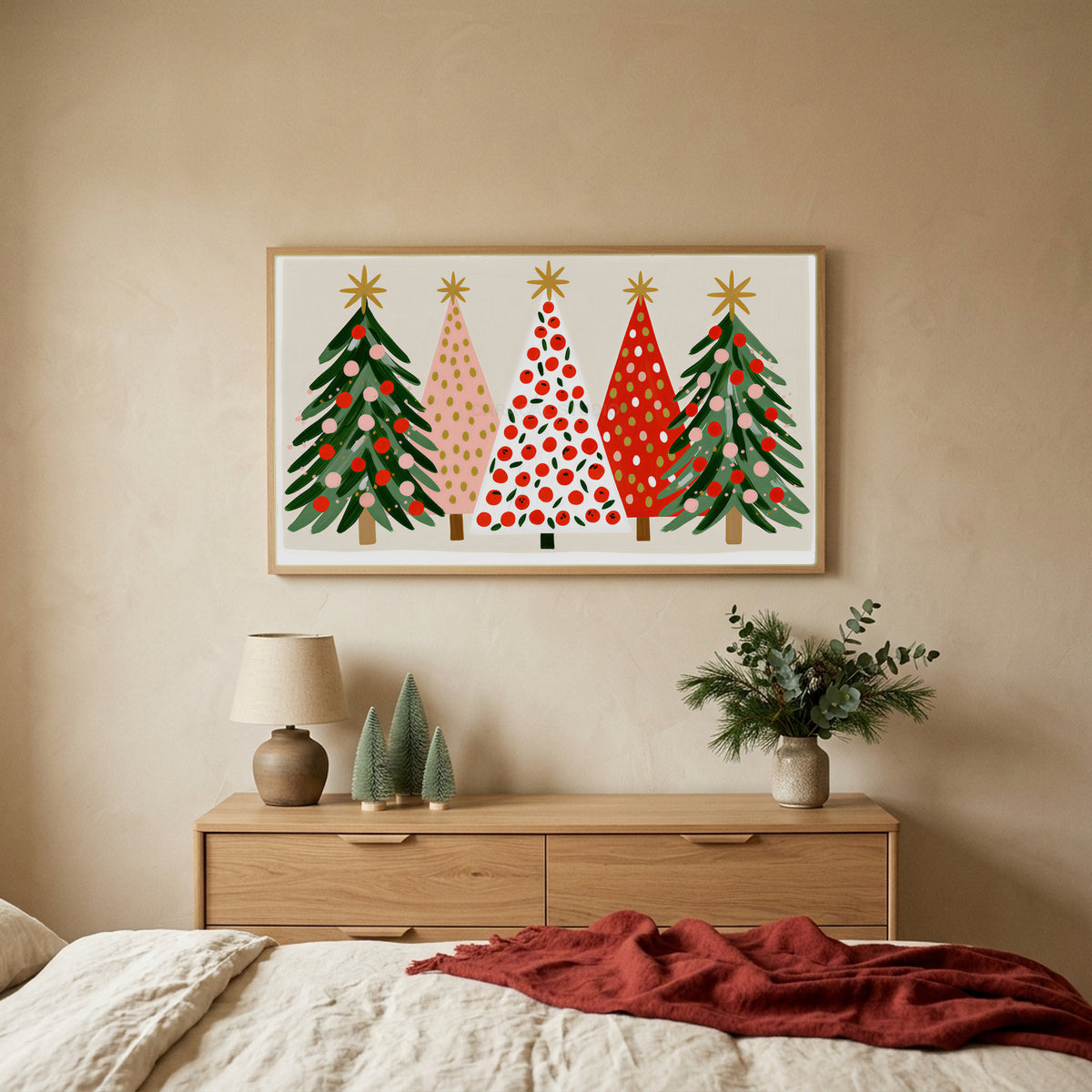Christmas tree row TV art above an oak dresser with small bottle-brush trees in a calm bedroom