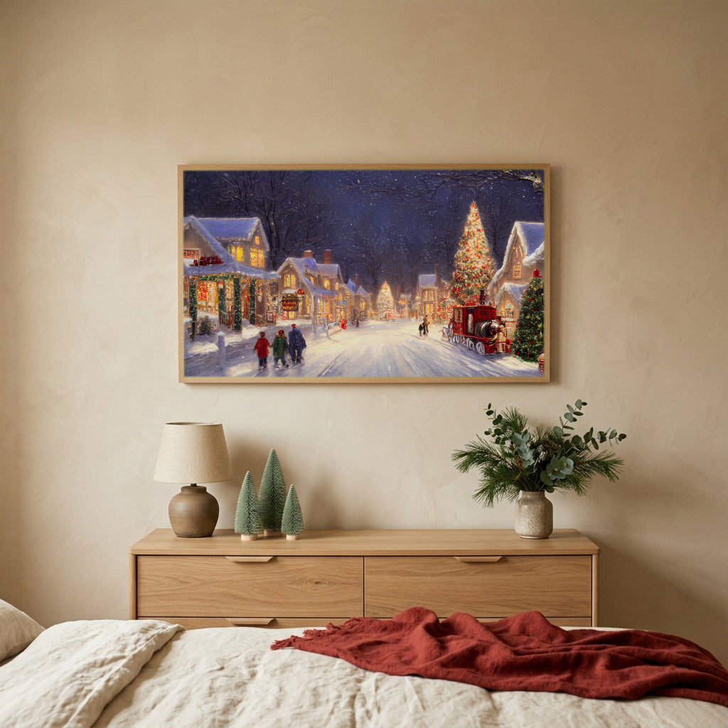 Snowy village with a red truck Christmas TV art above an oak dresser with small bottle-brush trees in a calm bedroom