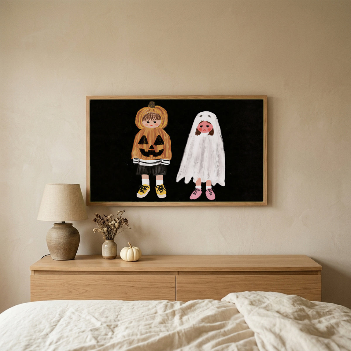 Trick-or-treaters Halloween TV art above an oak dresser in a calm bedroom