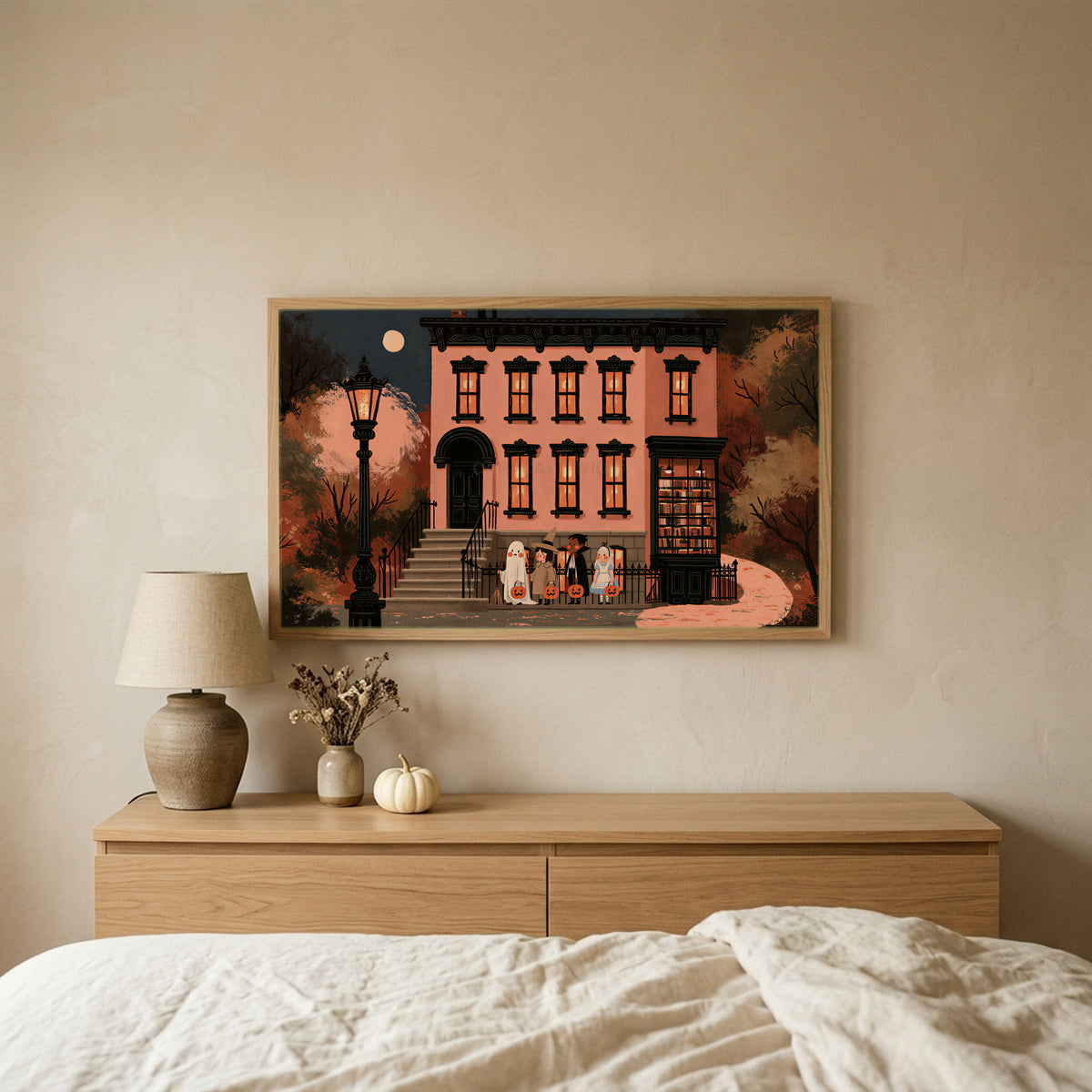 Trick or treat brownstone TV art above an oak dresser in a calm bedroom