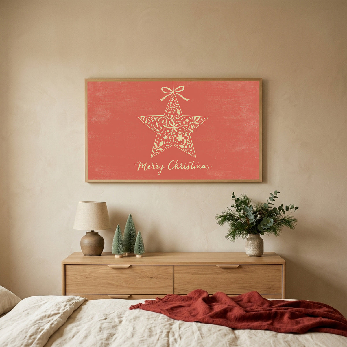 Star ornament TV art above an oak dresser with small bottle-brush trees in a calm bedroom