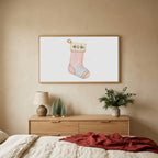 Cat stocking TV art above an oak dresser with small bottle-brush trees in a calm bedroom