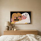 Jack-o'-lantern and ghost Halloween TV art above an oak dresser in a calm bedroom