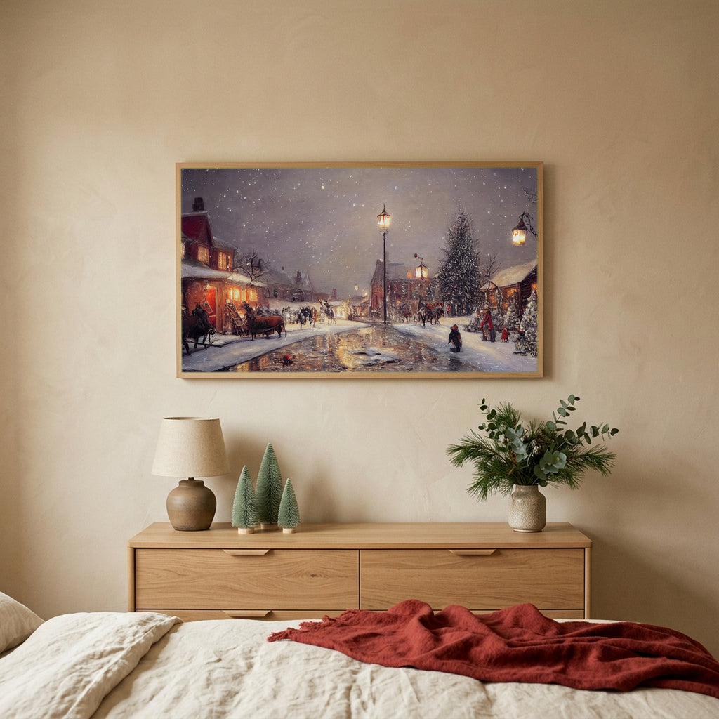 Snowy village at night Christmas TV art above an oak dresser with small bottle-brush trees in a calm bedroom