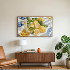 Lemons and olive oil art on a TV above a walnut credenza with a brass lamp and a monstera plant