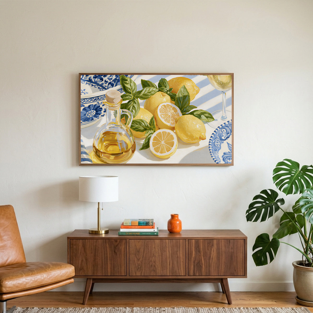 Lemons and olive oil art on a TV above a walnut credenza with a brass lamp and a monstera plant