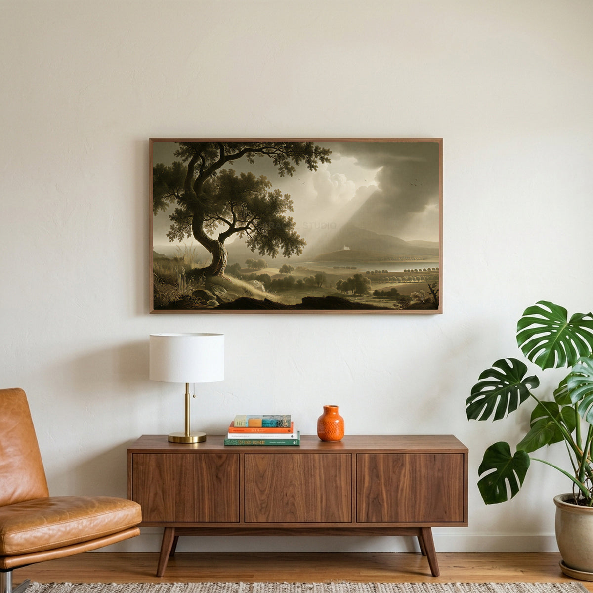 Vintage tree landscape art on a TV above a walnut credenza with a brass lamp and a monstera plant