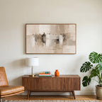 Neutral abstract figures art on a TV above a walnut credenza with a brass lamp and a monstera plant