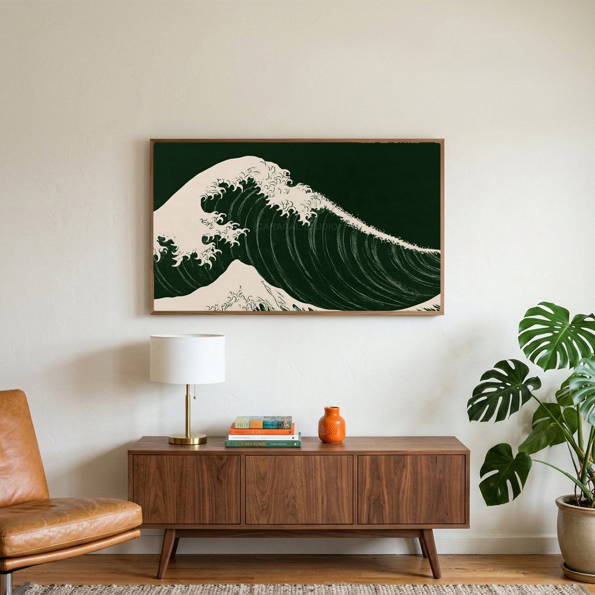 Japanese wave art on a TV above a walnut credenza with a brass lamp and a monstera plant