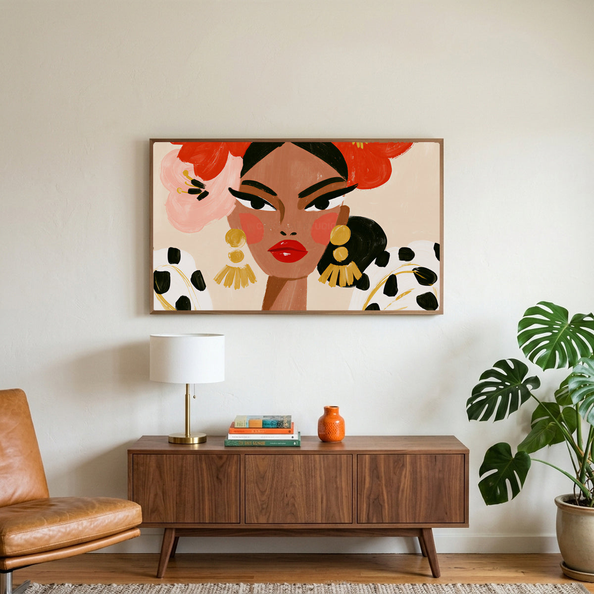 Fashion portrait art on a TV above a walnut credenza with a brass lamp and a monstera plant