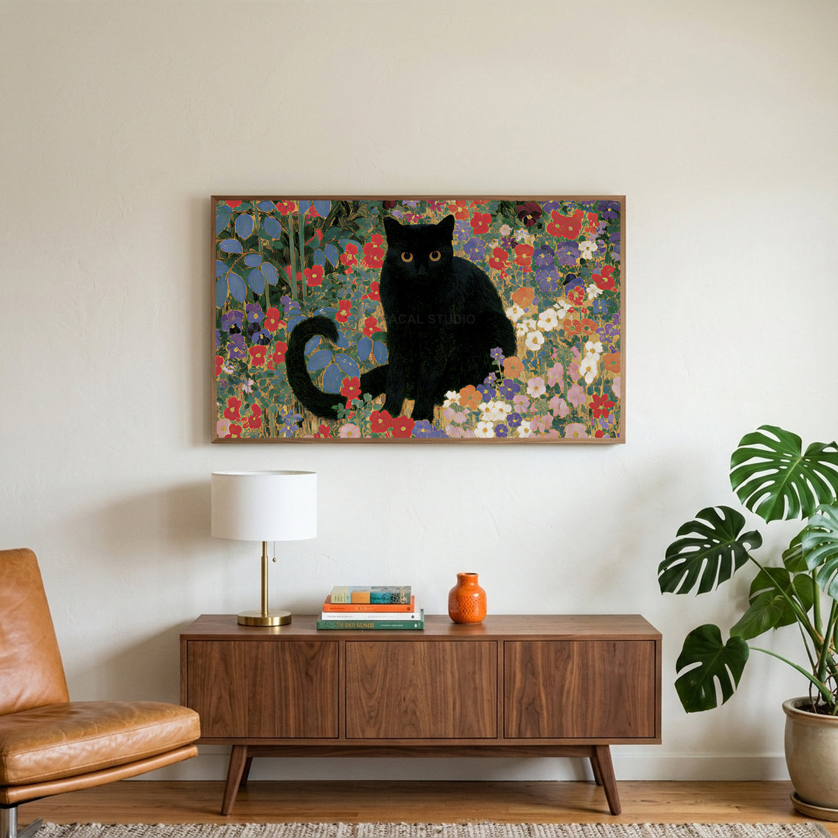 Black cat garden art on a TV above a walnut credenza with a brass lamp and a monstera plant
