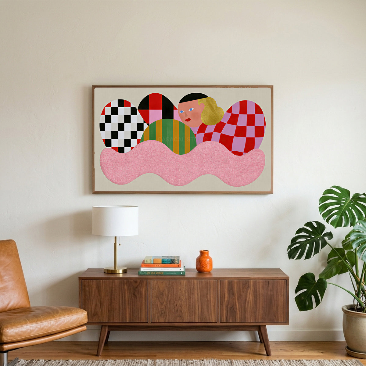 Checkered shapes portrait art on a TV above a walnut credenza with a brass lamp and a monstera plant