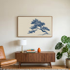 Blue ink tree art on a TV above a walnut credenza with a brass lamp and a monstera plant
