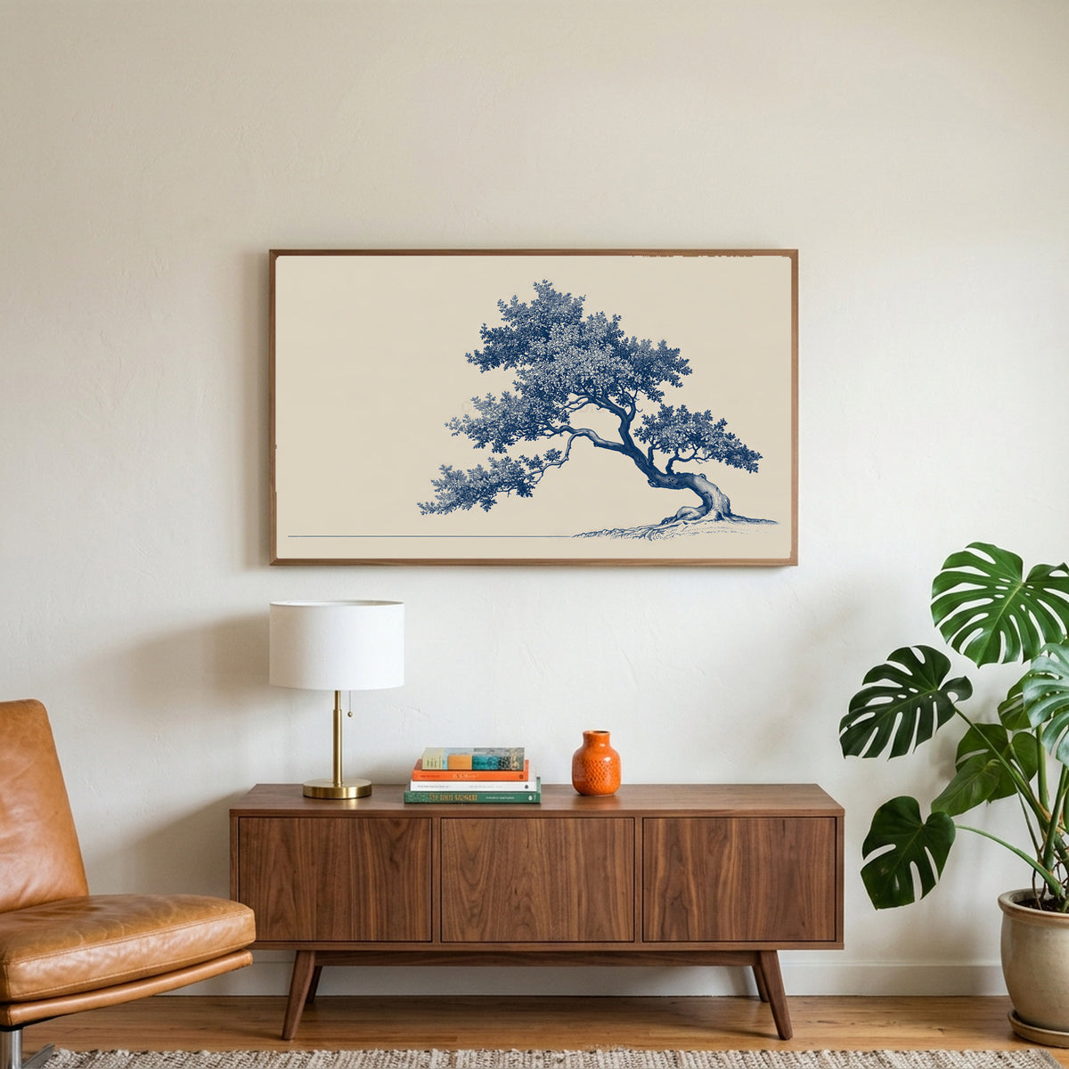 Blue ink tree art on a TV above a walnut credenza with a brass lamp and a monstera plant