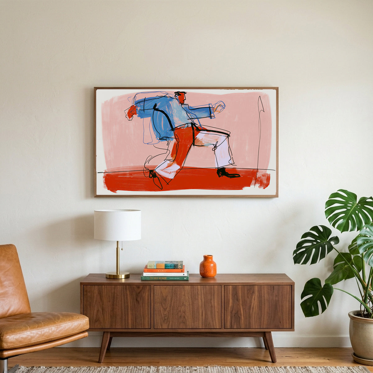 Dancing man line art on a TV above a walnut credenza with a brass lamp and a monstera plant
