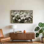 White anemone field art on a TV above a walnut credenza with a brass lamp and a monstera plant