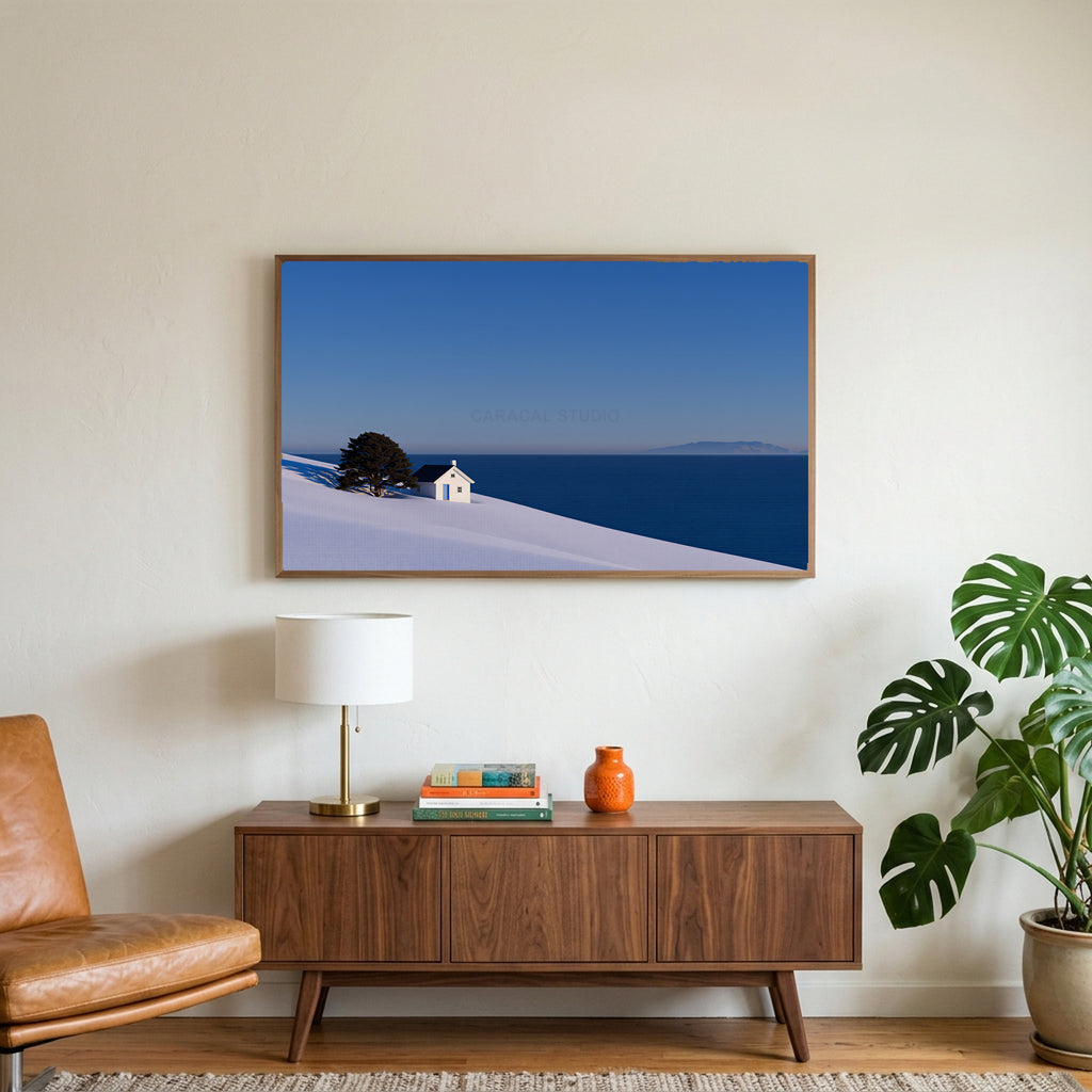 Snowy seaside cottage art on a TV above a walnut credenza with a brass lamp and a monstera plant