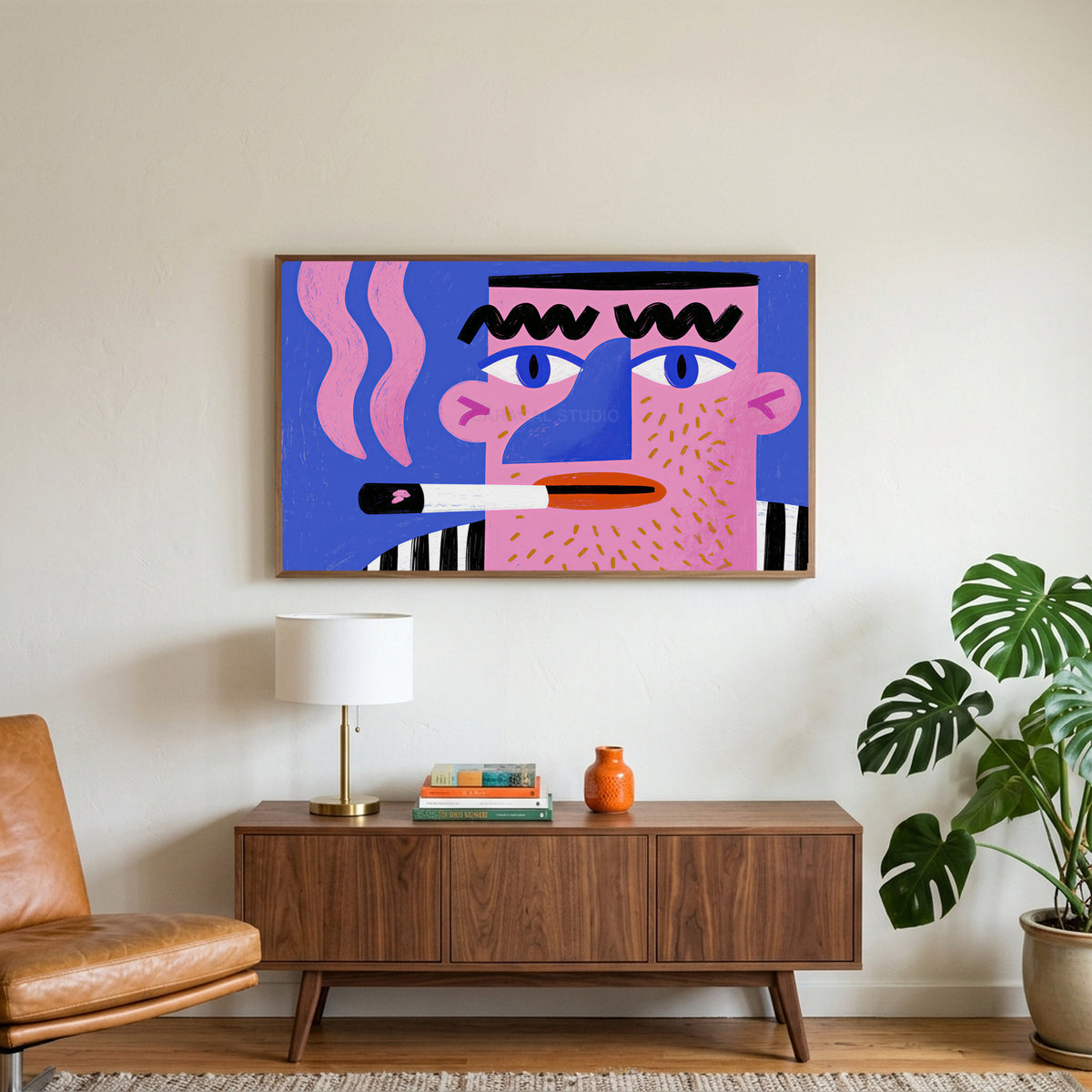 Pop art face art on a TV above a walnut credenza with a brass lamp and a monstera plant