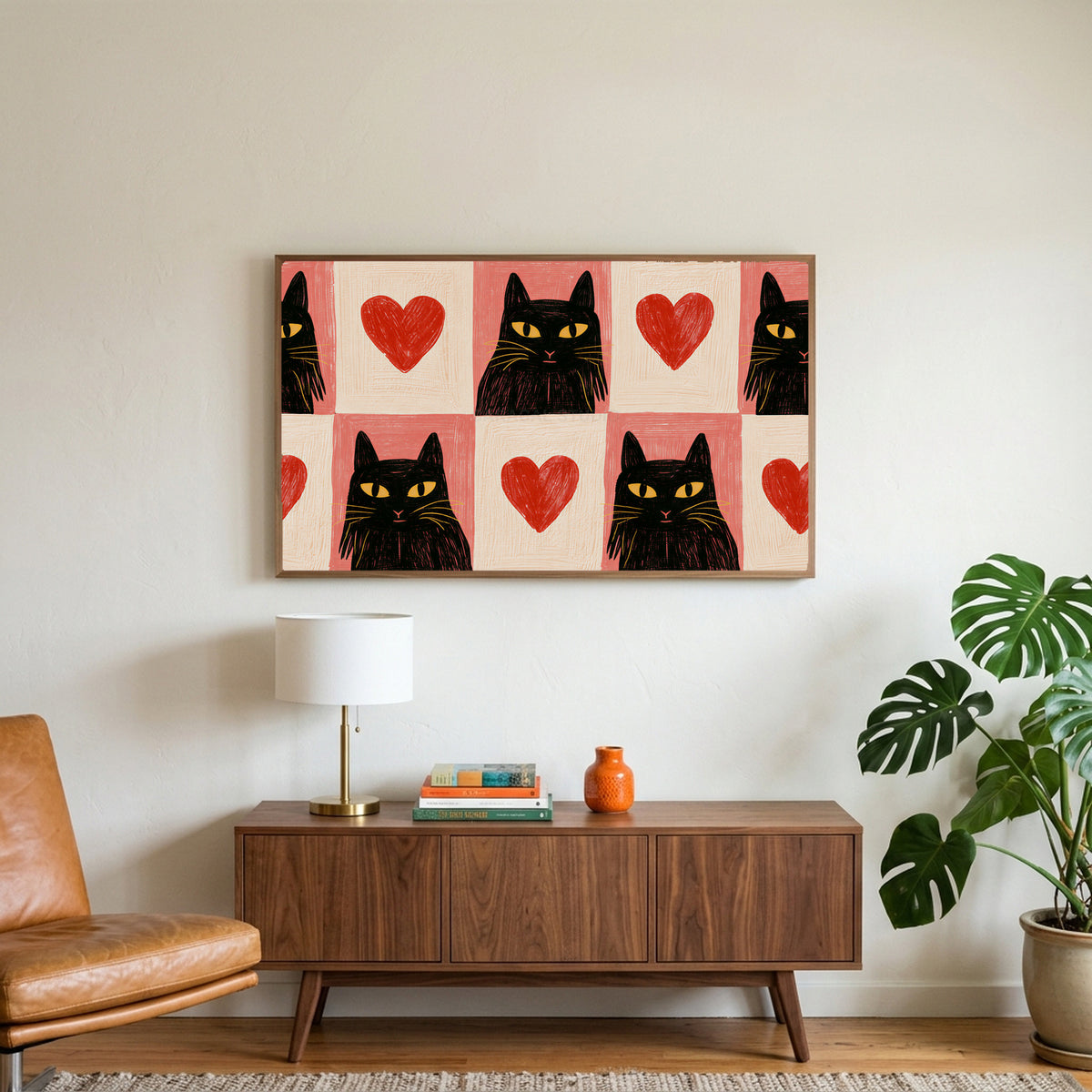 Black cat and heart art on a TV above a walnut credenza with a brass lamp and a monstera plant