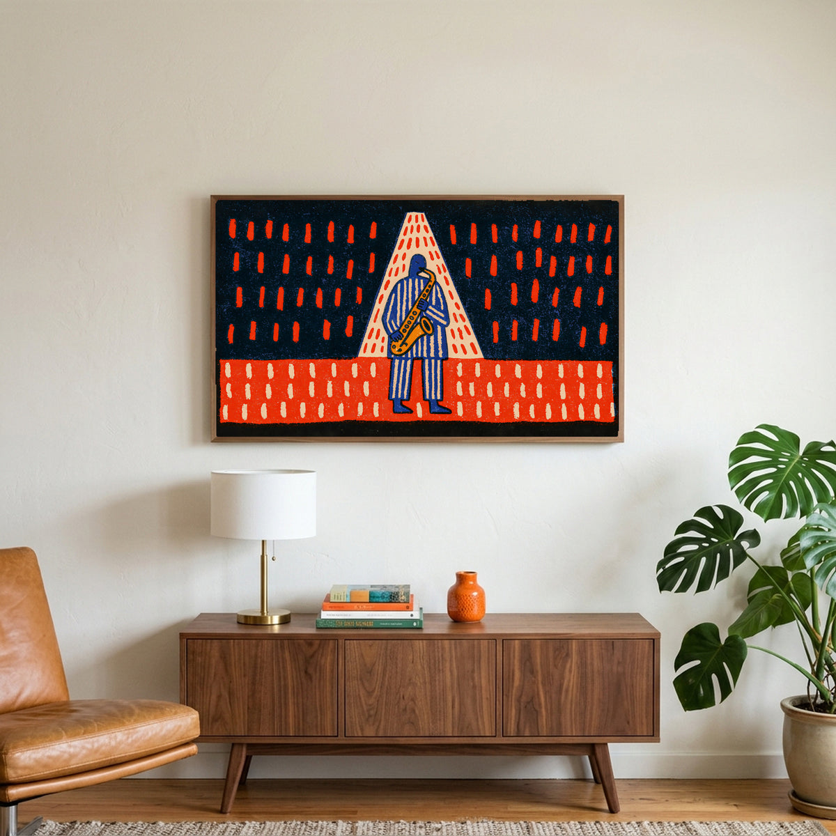 Jazz saxophone art on a TV above a walnut credenza with a brass lamp and a monstera plant