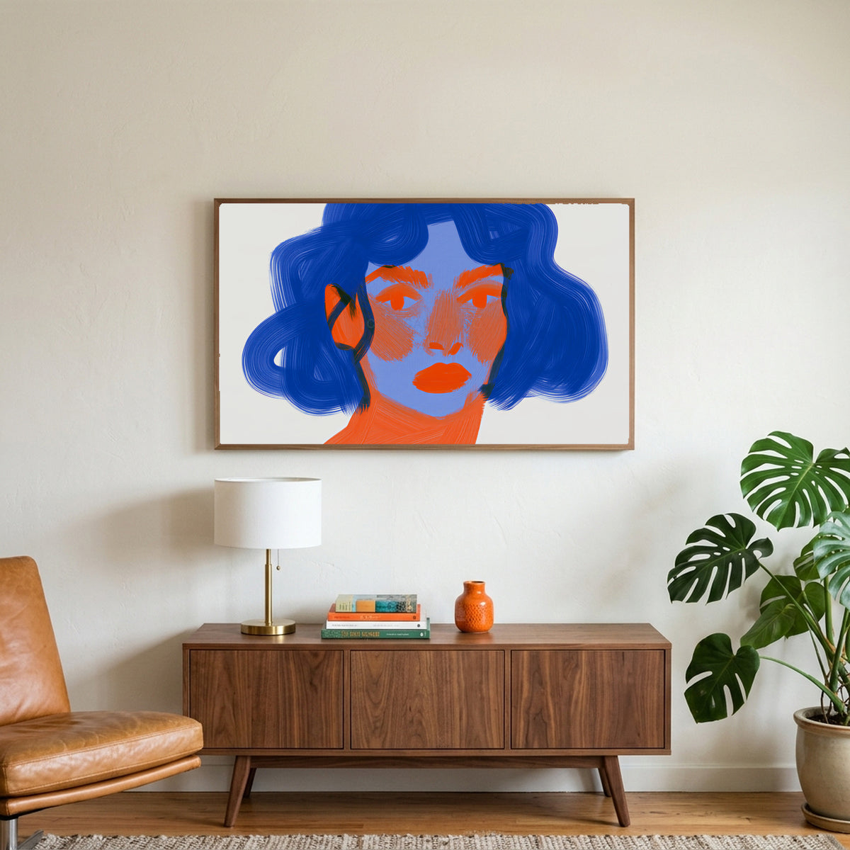 Blue hair portrait art on a TV above a walnut credenza with a brass lamp and a monstera plant