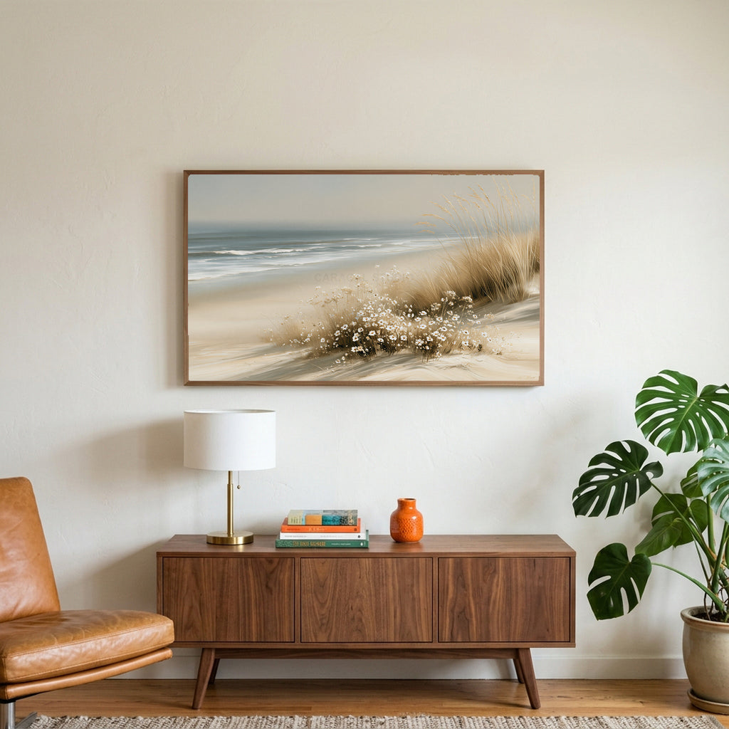 Dune grass and daisies art on a TV above a walnut credenza with a brass lamp and a monstera plant