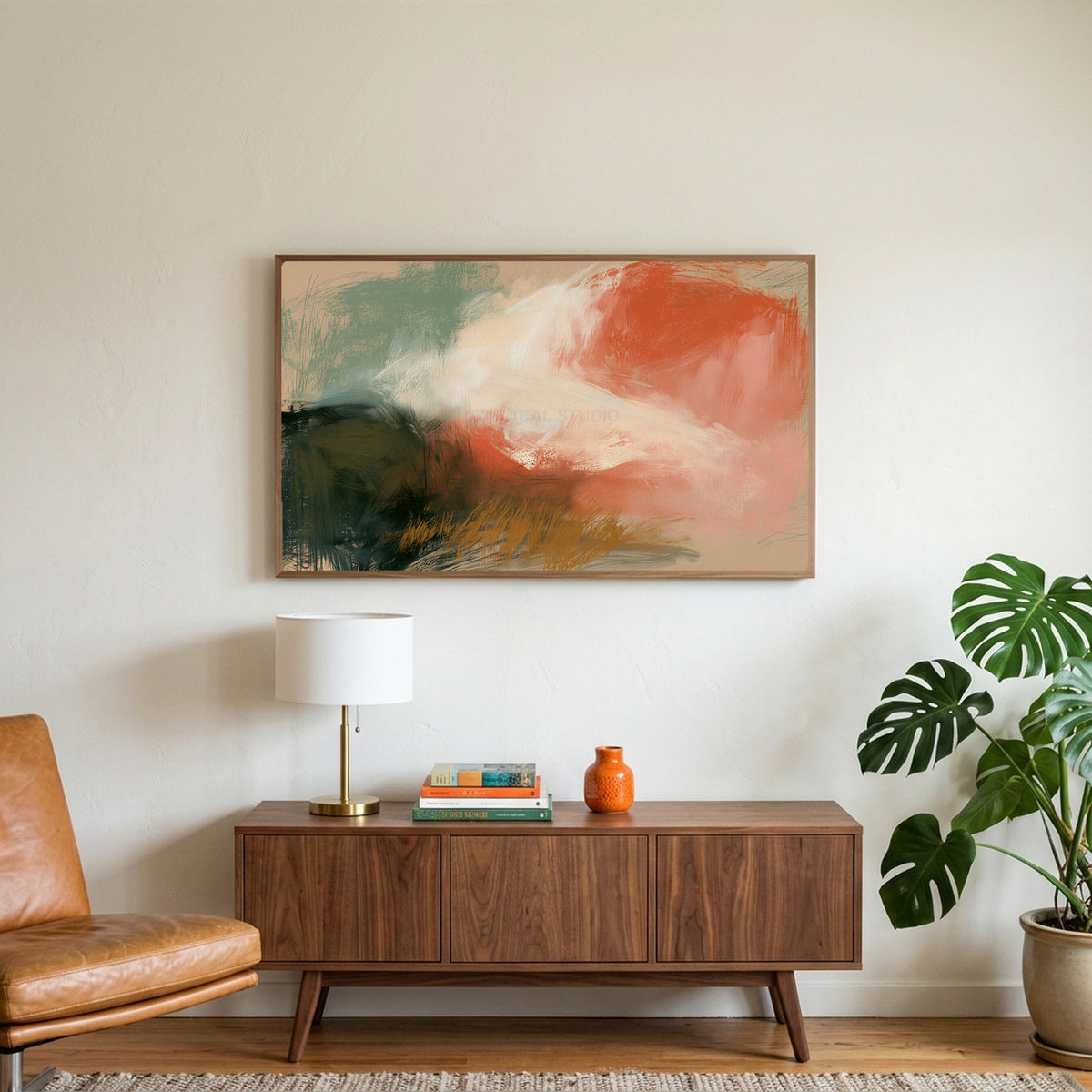 Chalk pastel abstract art on a TV above a walnut credenza with a brass lamp and a monstera plant