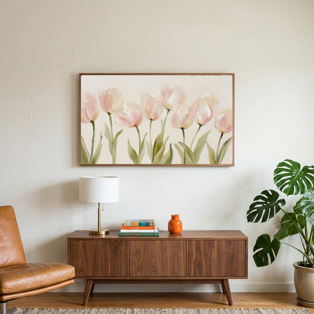 Pink tulip art on a TV above a walnut credenza with a brass lamp and a monstera plant