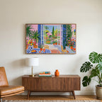 Mediterranean garden view art on a TV above a walnut credenza with a brass lamp and a monstera plant