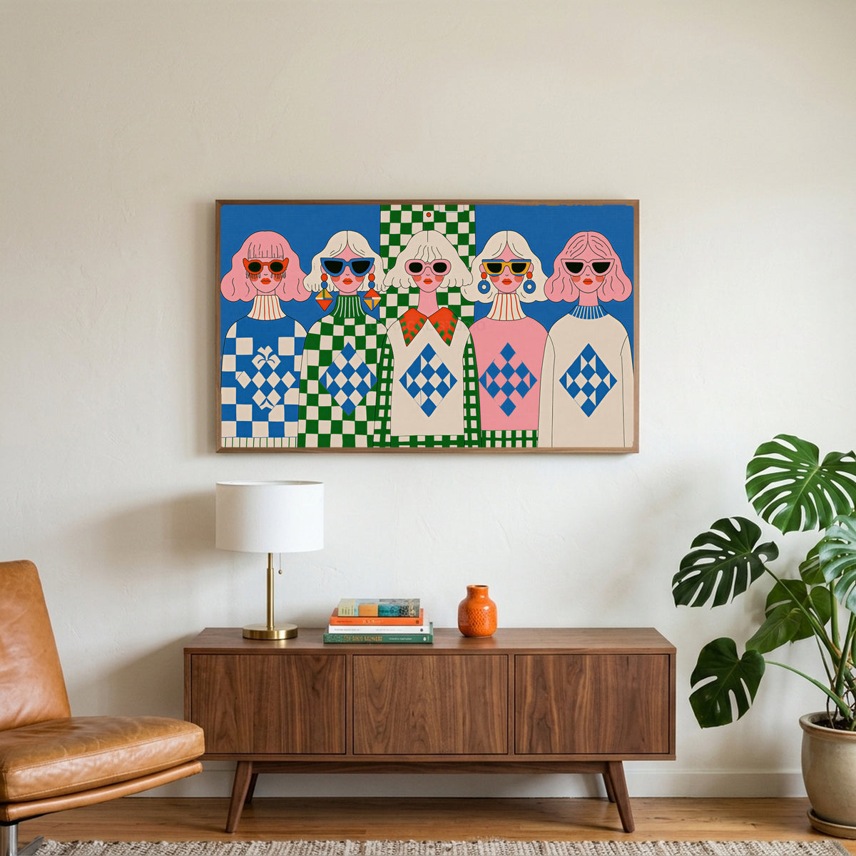 Retro women in sunglasses art on a TV above a walnut credenza with a brass lamp and a monstera plant