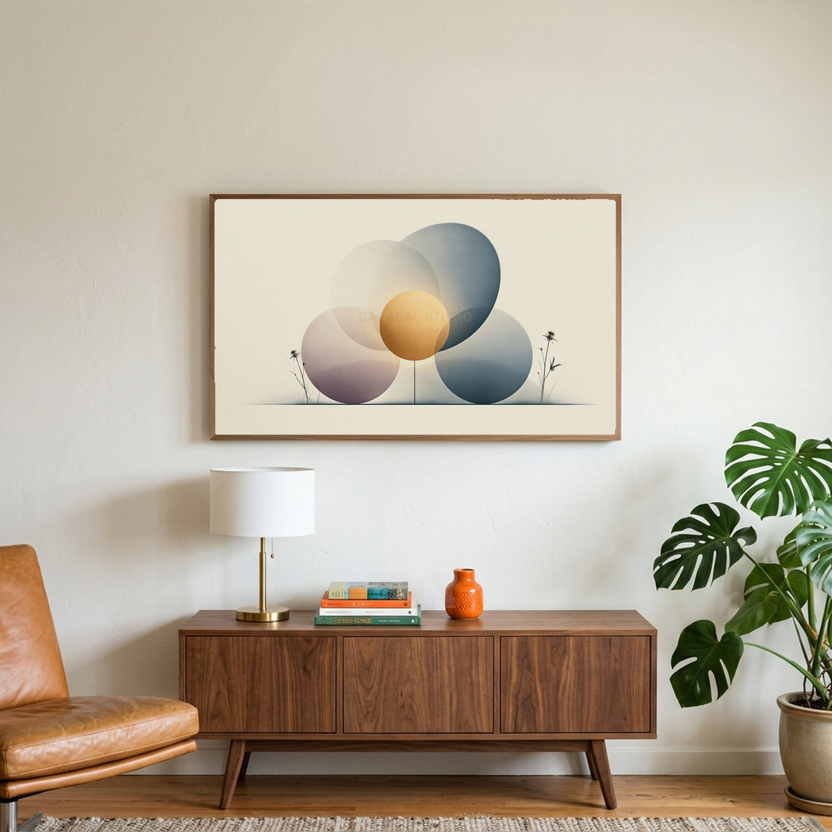 Abstract circles art on a TV above a walnut credenza with a brass lamp and a monstera plant