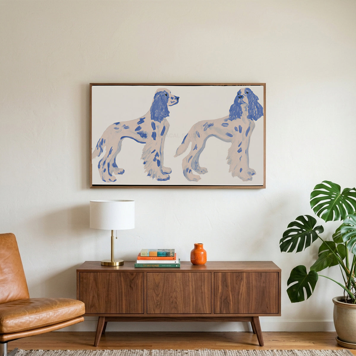 Spaniel figurines art on a TV above a walnut credenza with a brass lamp and a monstera plant