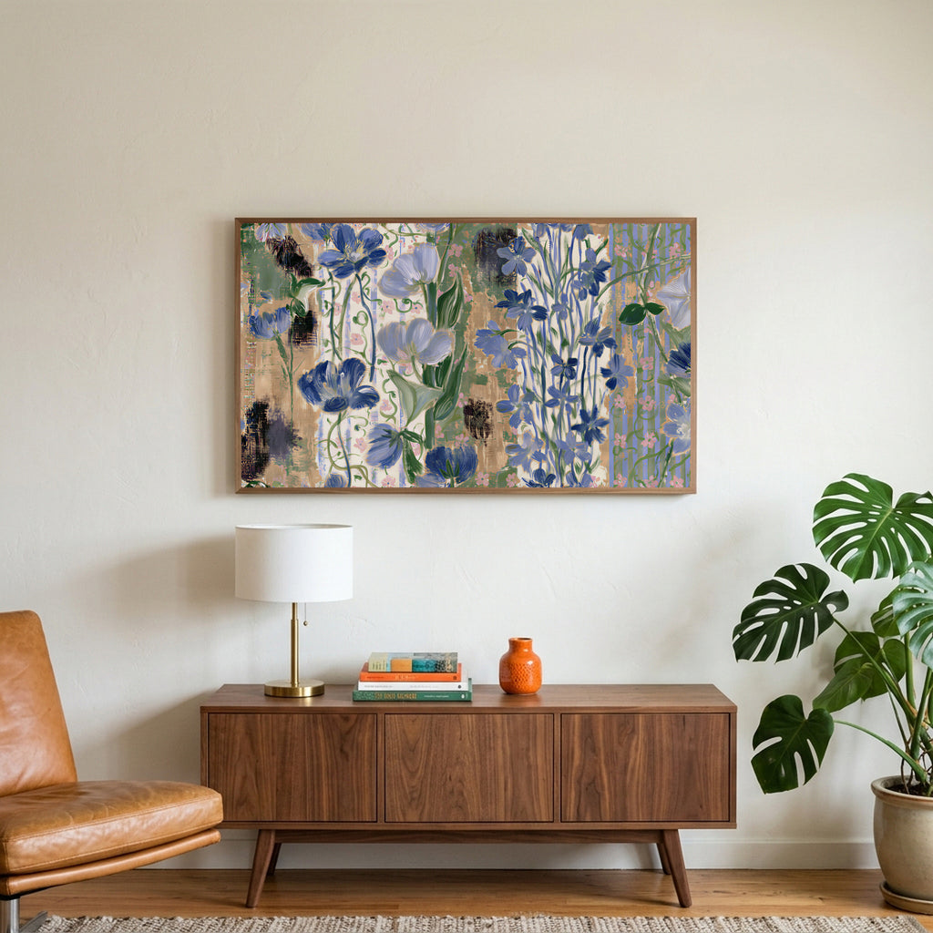 Vintage blue florals art on a TV above a walnut credenza with a brass lamp and a monstera plant