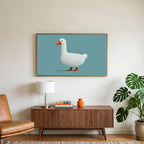 White duck art on a TV above a walnut credenza with a brass lamp and a monstera plant