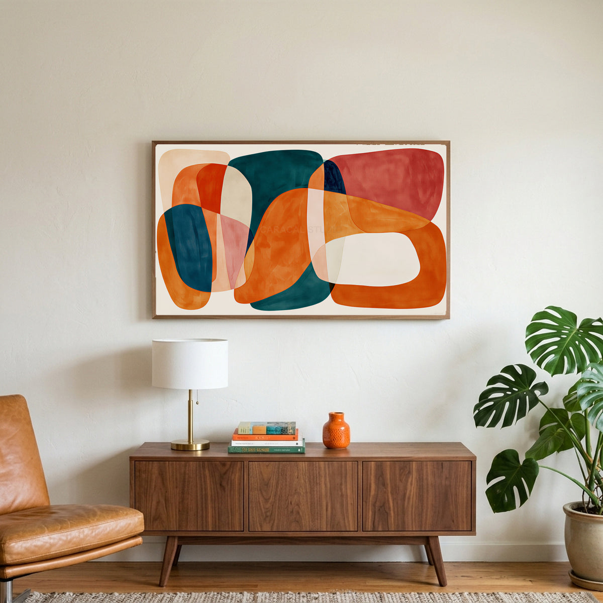 Organic shapes art on a TV above a walnut credenza with a brass lamp and a monstera plant