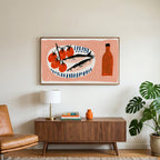 Sardines and tomatoes art on a TV above a walnut credenza with a brass lamp and a monstera plant