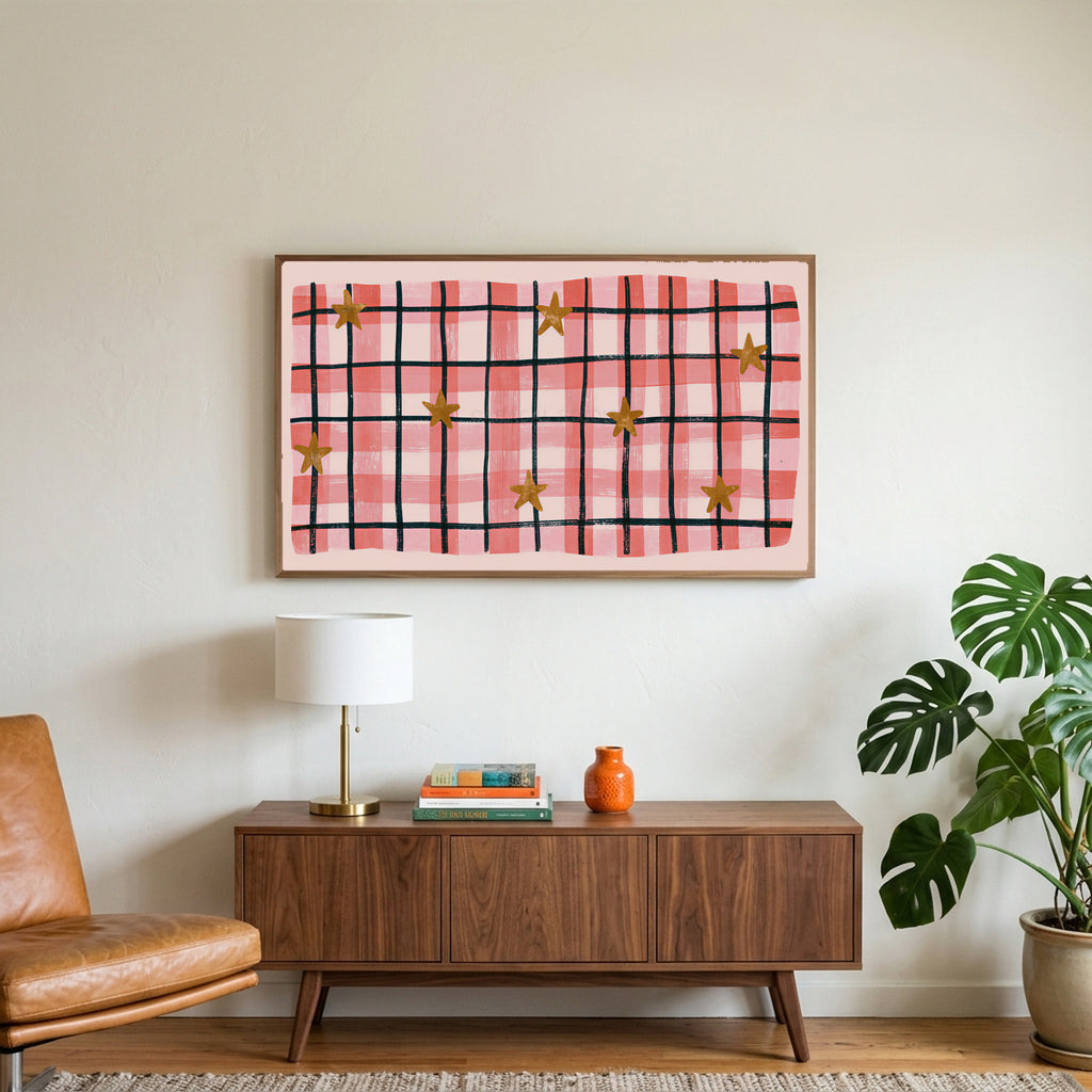 Gingham plaid with stars art on a TV above a walnut credenza with a brass lamp and a monstera plant